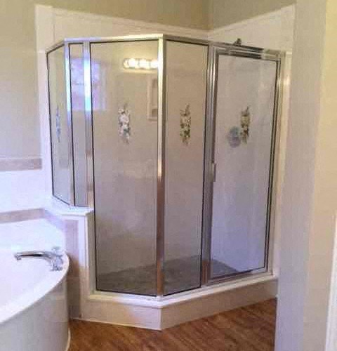 a bathroom with a shower with glass doors
