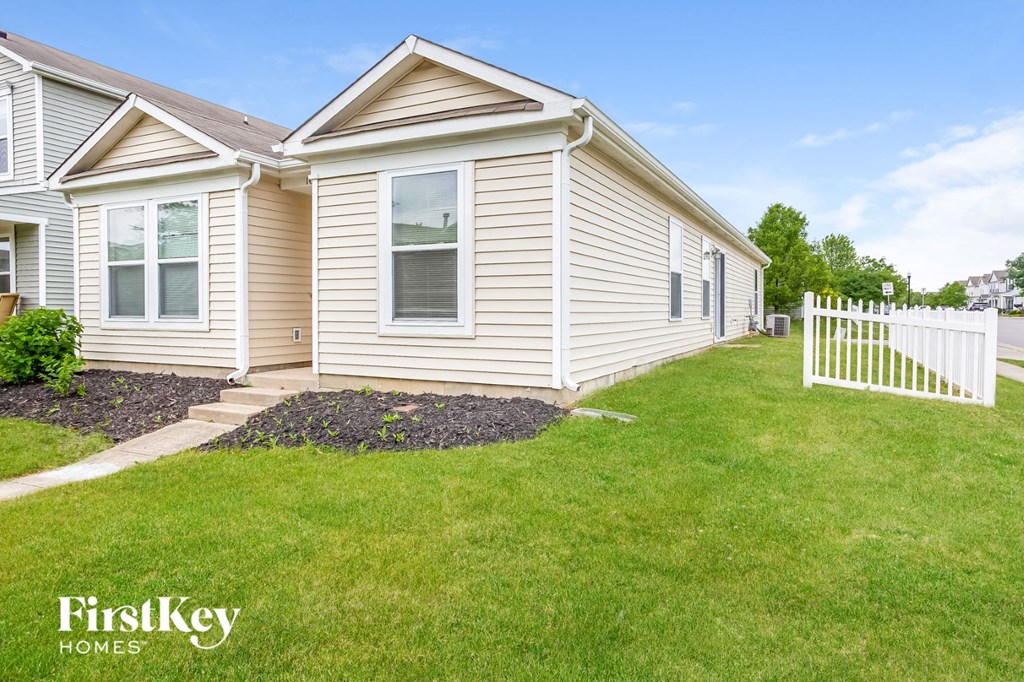 a white house with a white fence in front of it