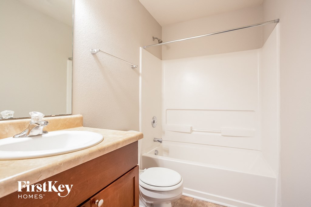 a bathroom with a sink and a toilet and a shower