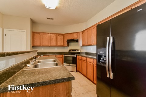 a kitchen with wooden cabinets and stainless steel appliances and granite counter tops