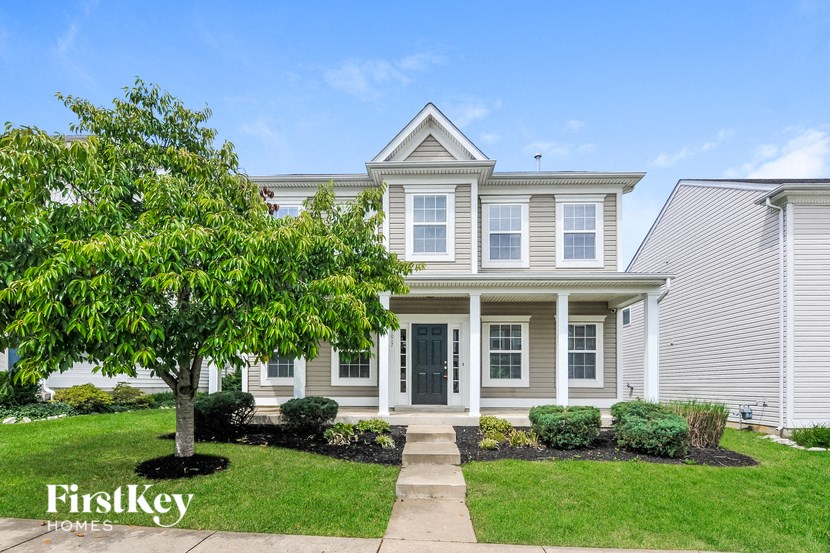 a white house with a tree in front of it