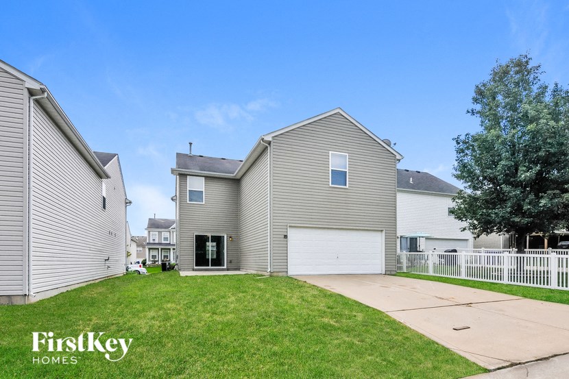 a with a yard and a white fence