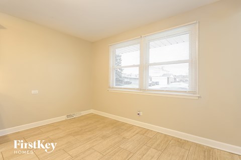 a living room with a window and a wooden floor