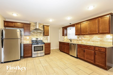 a kitchen with wooden cabinets and stainless steel appliances
