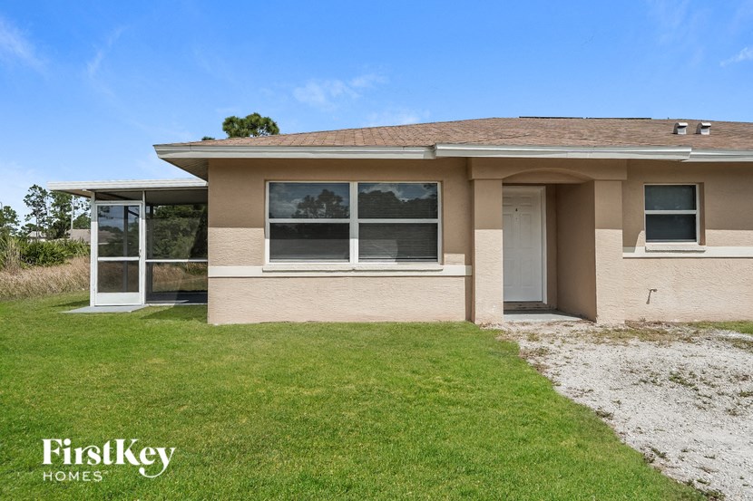 A house with a brown roof and a white door is for sale.