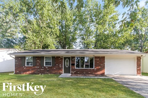a small brick house with a white garage door