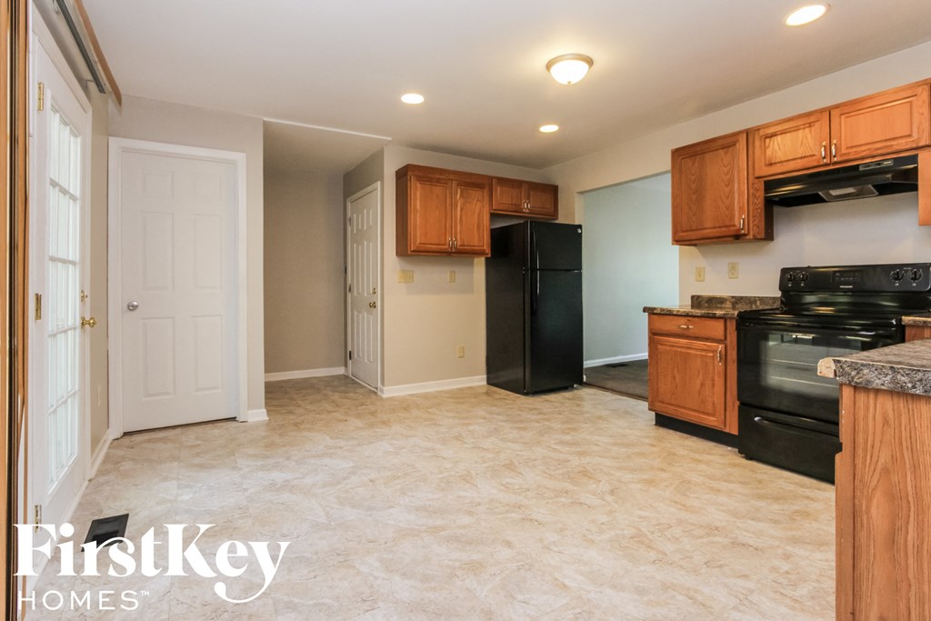 a kitchen with black appliances and wooden cabinets