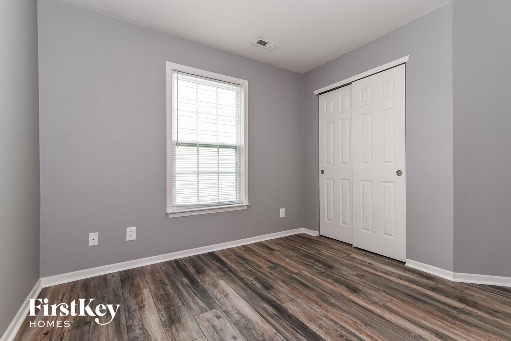 the interior of a home with a white door and wood floors