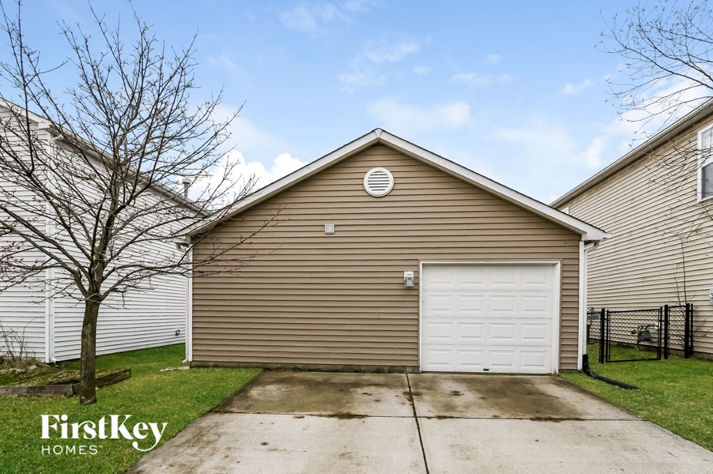 a garage with a white garage door on the side of a house