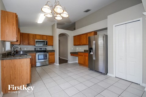 a kitchen with wooden cabinets and stainless steel appliances