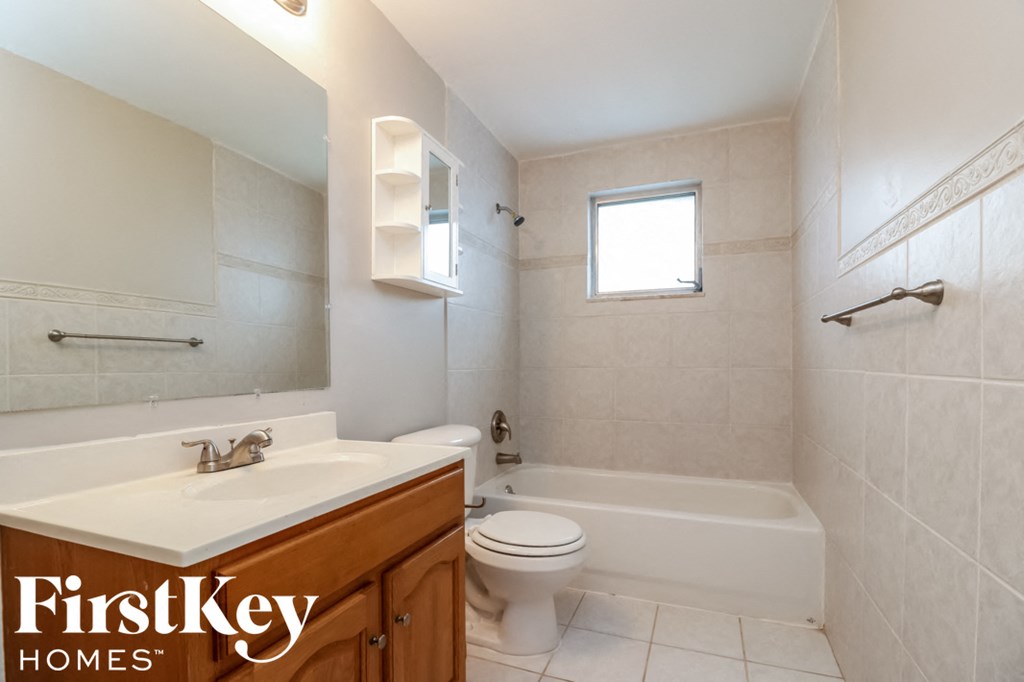 a bathroom with a sink toilet and a bath tub