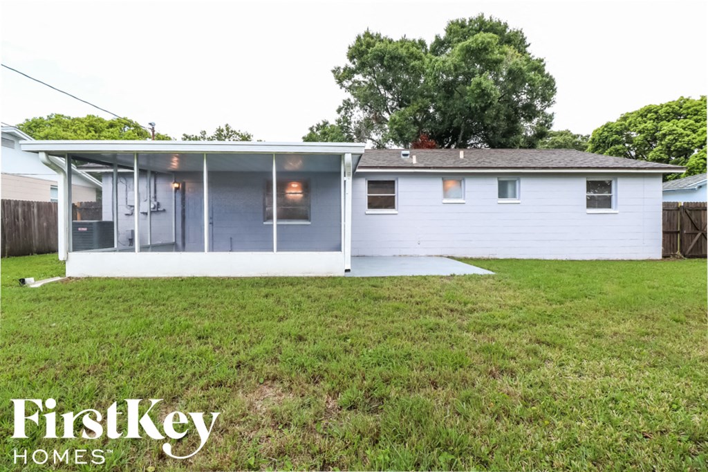 a small white house with a lawn in front of it