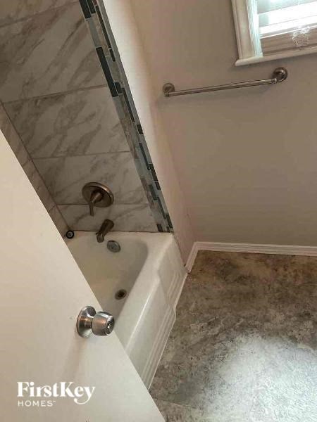 a bathroom with a shower and a bath tub