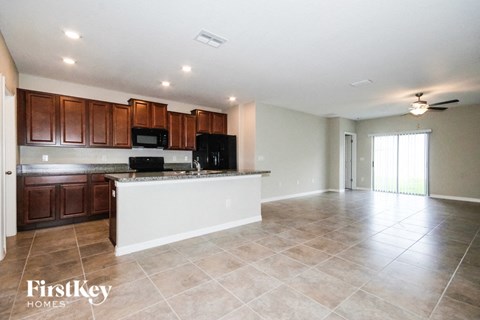 A kitchen with brown cabinets and a white island.