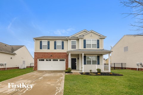 A two-story house with a garage is for sale.