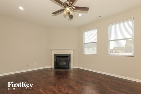 A room with a fireplace and a ceiling fan.