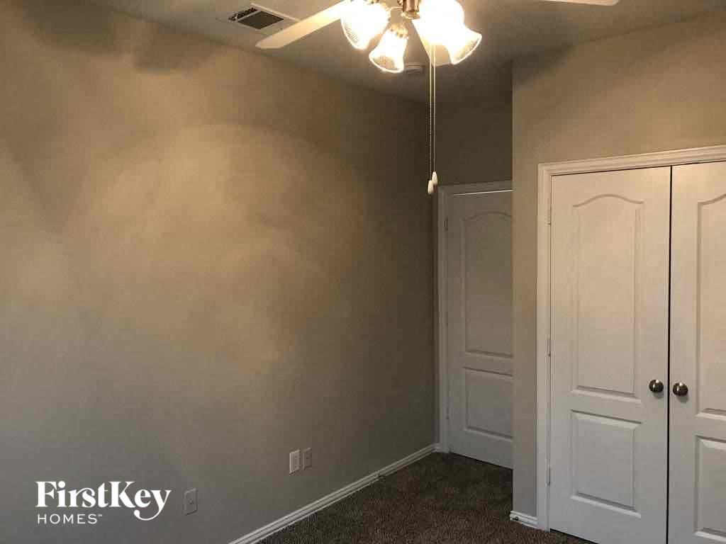 a bedroom with a closet and a ceiling fan