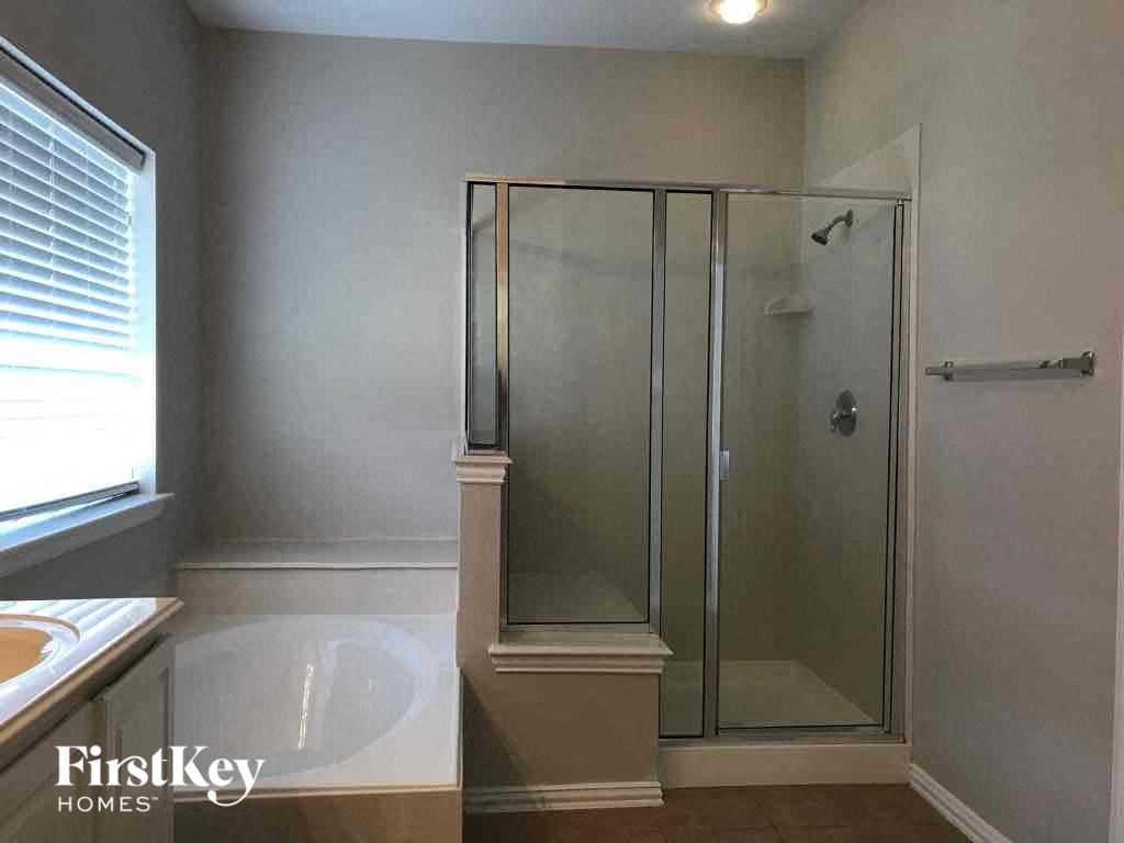 a small bathroom with a shower and a sink