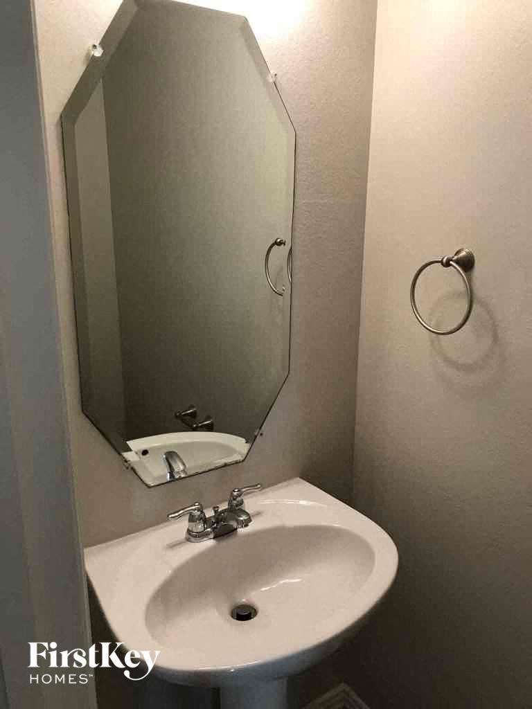 a small bathroom with a sink and a mirror
