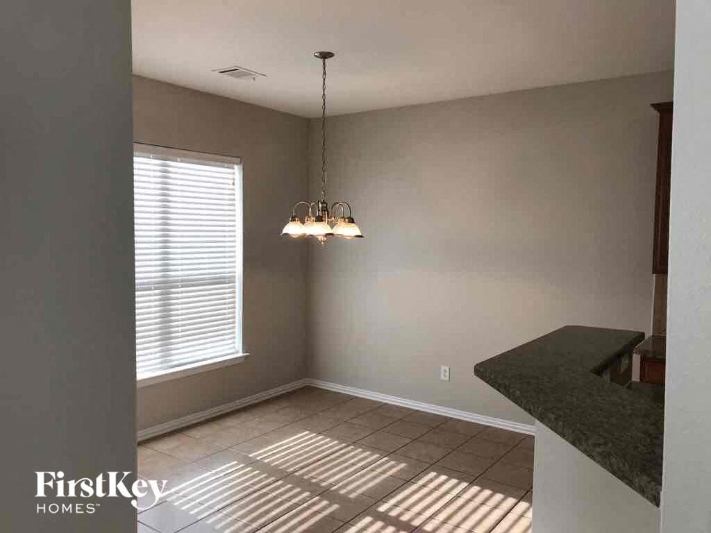 a dining room with a chandelier and a window