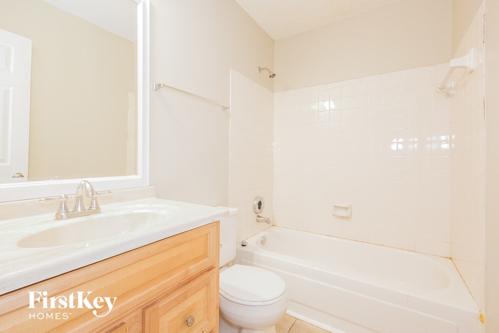 a bathroom with a sink toilet and a bath tub