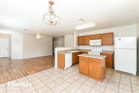 A kitchen with wooden cabinets and a white fridge.