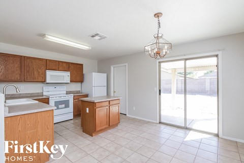 A kitchen with wooden cabinets and a white oven.