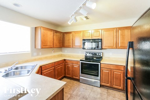 A kitchen with wooden cabinets and stainless steel appliances.