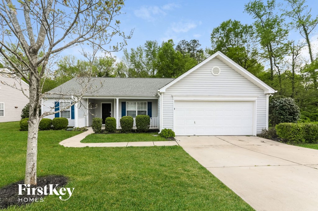 A house with a white garage door is for sale.
