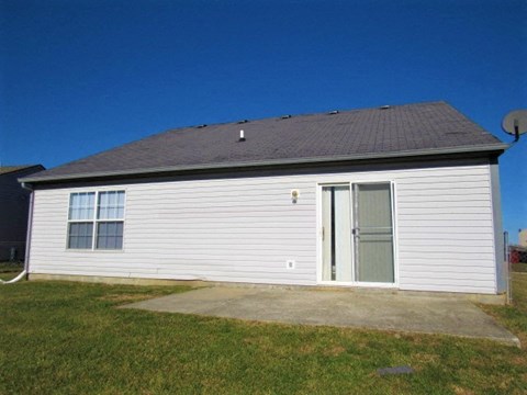 a white building with a porch and a door