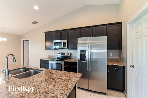 a kitchen with stainless steel appliances and granite counter tops