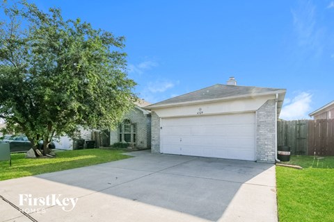 a home with a white garage door and a driveway