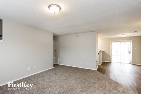 the living room and dining room of an apartment