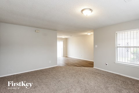 the living room and dining room of an apartment