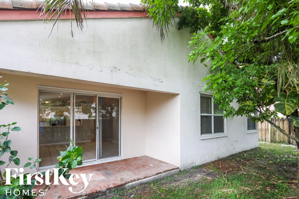 a small white house with sliding glass doors