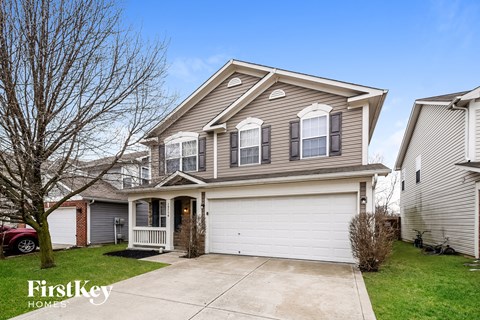 A two-story house with a garage is for sale.