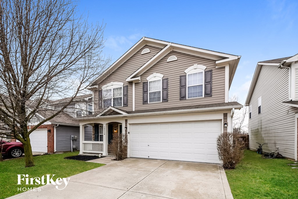 A two-story house with a garage is for sale.