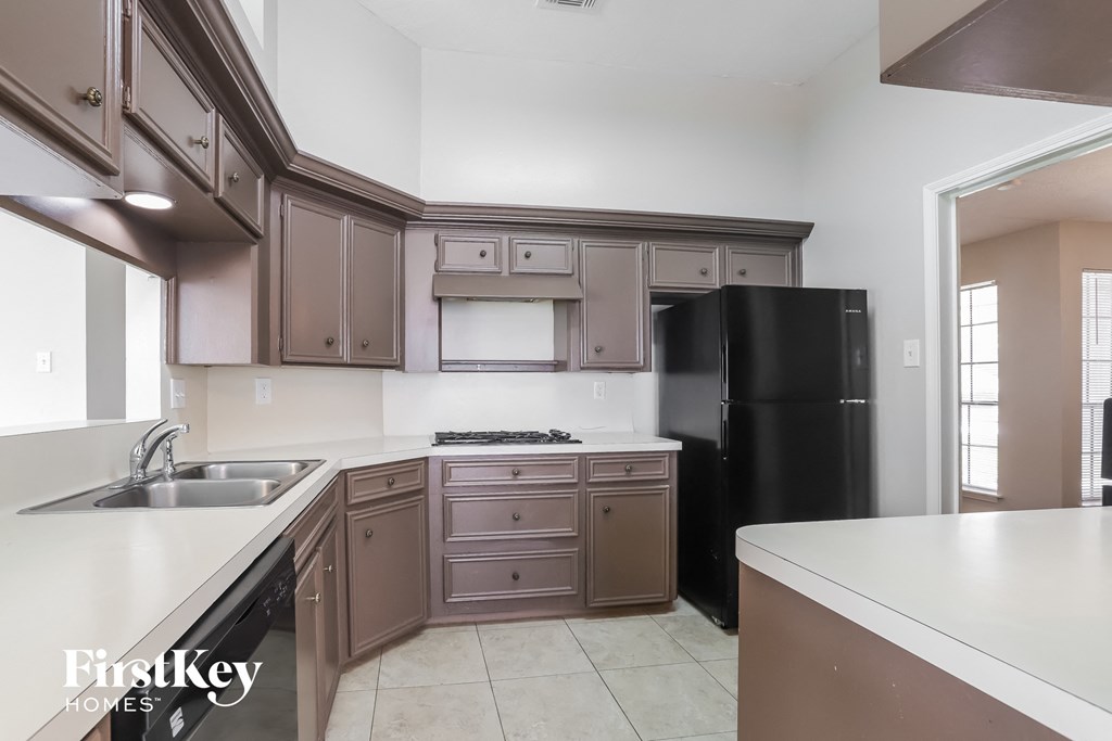 a kitchen with black appliances and white counter tops