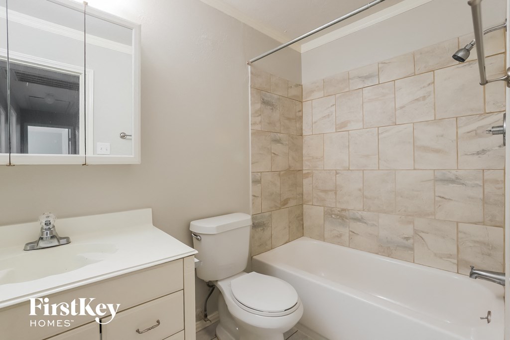 a bathroom with a tub and a toilet and a sink