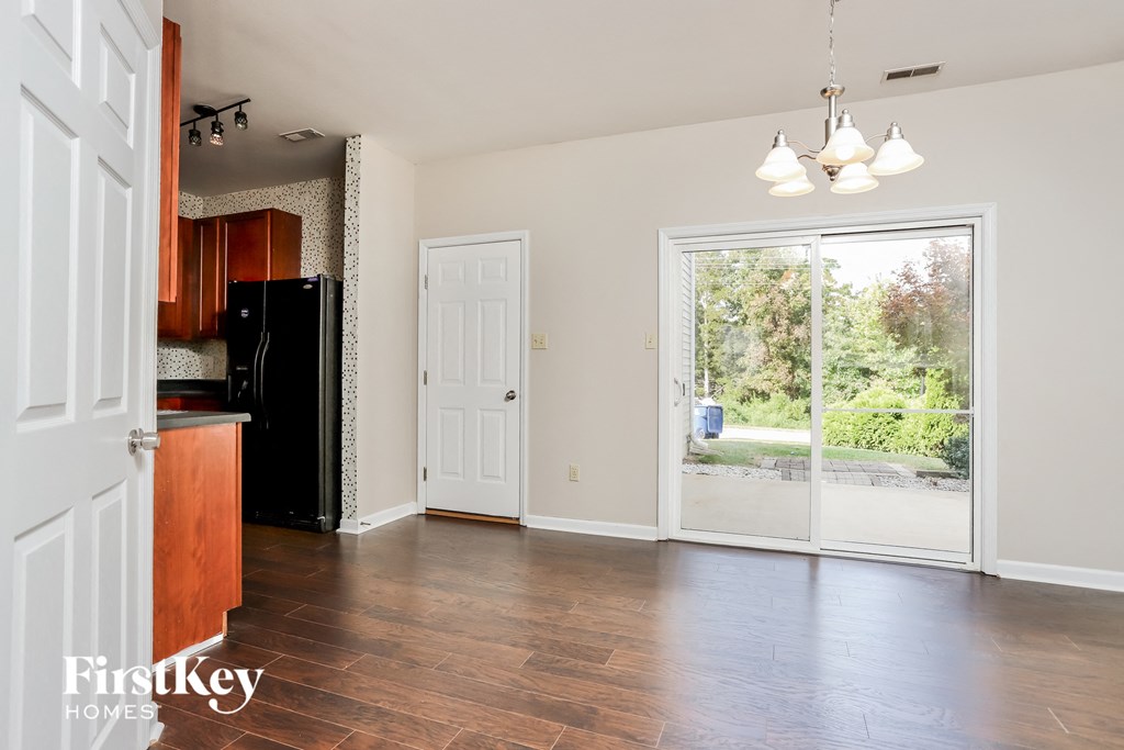 an empty kitchen and living room with a door to a patio