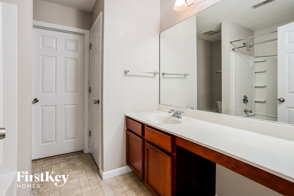 a bathroom with a sink and a mirror and a shower