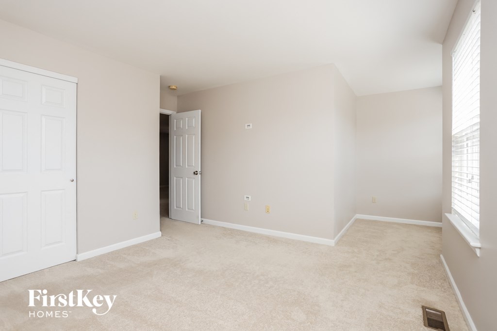 an empty room with a door and a closet
