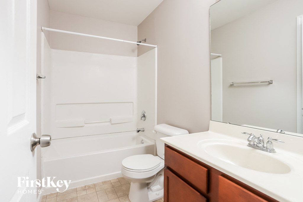 a bathroom with a sink toilet and a bath tub