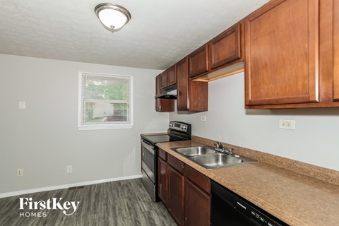 A kitchen with wooden cabinets and a sink.