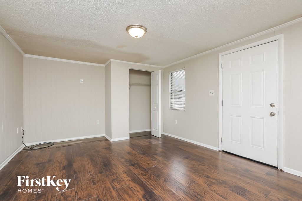 a living room with wood flooring and a white door