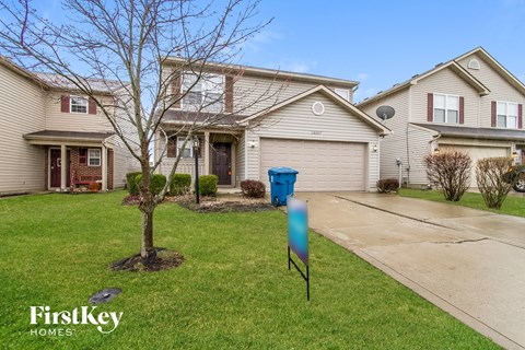 a home with a blue mailbox in front of it