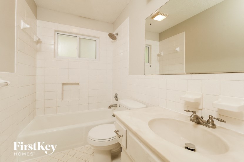 a white bathroom with a sink and a toilet