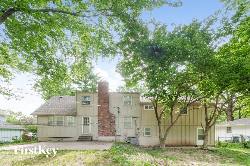 a large white house with trees in front of it