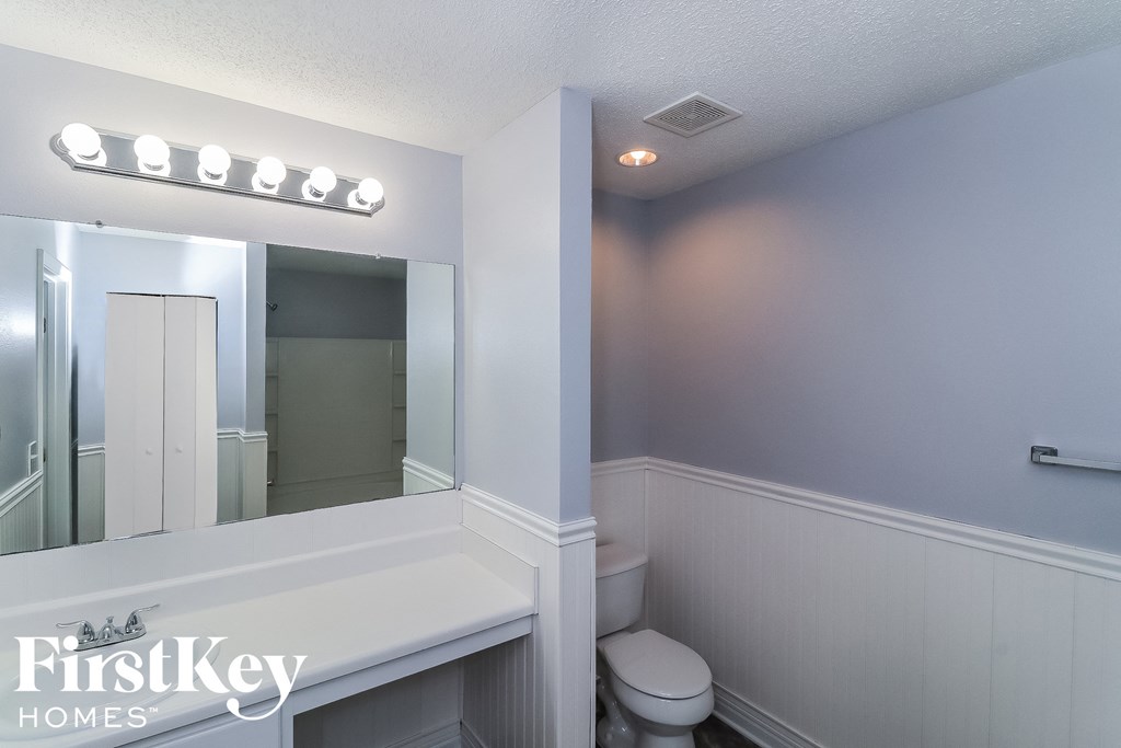 a small bathroom with a toilet and a mirror