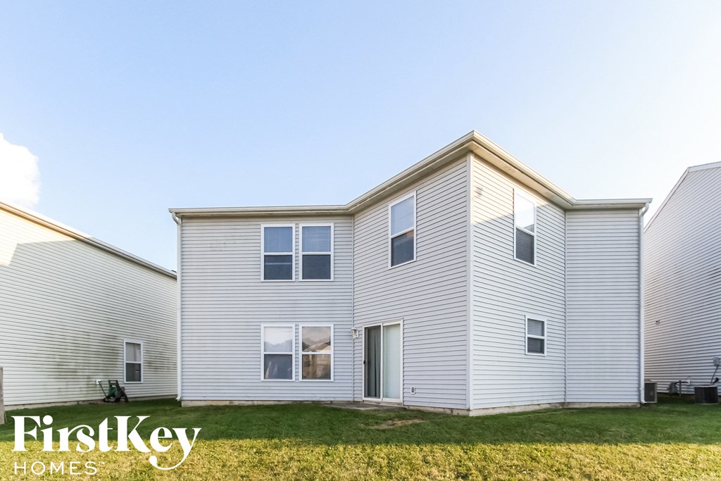 a white house with a lawn in front of it